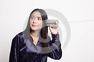 Young Asian woman with tin can phone