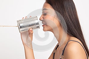 Young Asian woman with tin can phone