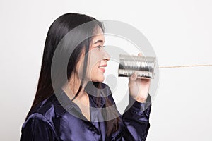 Young Asian woman with tin can phone