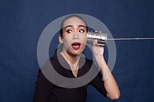 Young Asian woman with tin can phone