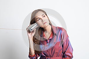 Young Asian woman with tin can phone