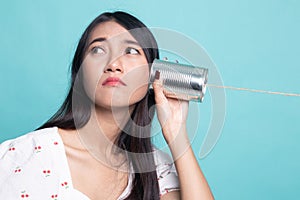 Young Asian woman with tin can phone