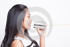 Young Asian woman with tin can phone