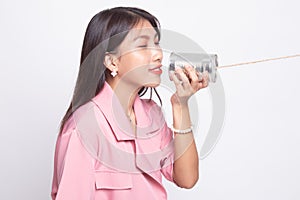 Young Asian woman with tin can phone