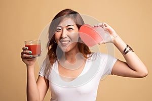 Young Asian woman with tomato juice and red heart