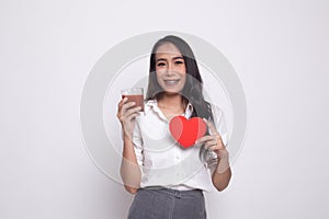 Young Asian woman with tomato juice and red heart