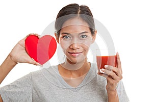 Young Asian woman with tomato juice and red heart.