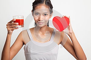 Young Asian woman with tomato juice and red heart.