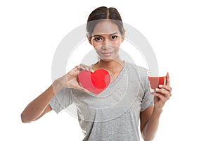 Young Asian woman with tomato juice and red heart.