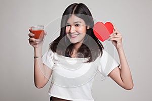 Young Asian woman with tomato juice and red heart.