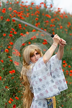 Young asian woman in traditional kimono trains fighting techniques with katana sword