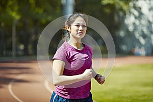 Young asian woman training outdoors