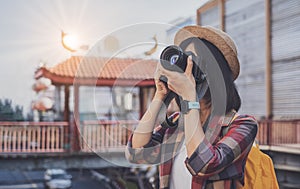 Young asian woman traveller is looking at the map at the train station, Travel and transportation concept. Traveler is waiting for