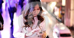 Young asian woman using her mobile phone