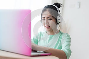 Young Asian woman using laptop computer