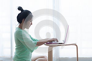 Young Asian woman using laptop computer