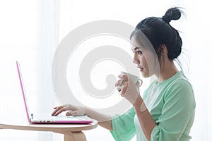 Young Asian woman using laptop computer