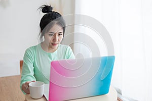 Young Asian woman using laptop computer