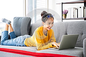 Young asian woman using laptop at house
