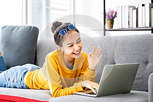 Young asian woman using laptop at house. Work at home