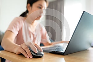 Young asian woman using laptop at house. Work at home