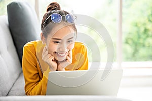 Young asian woman using laptop at house. Work at home, Video conference