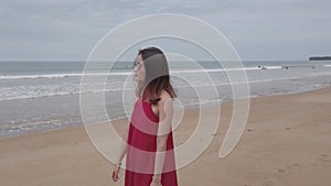 Young asian woman is walking relaxing on the beach at summer vacation