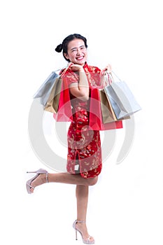 Young asian woman wearing chinese dress traditional cheongsam with Carrying a shopping bag and smile