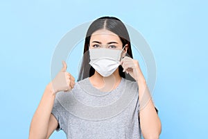 Young Asian woman wearing face mask to protect from germ and virus