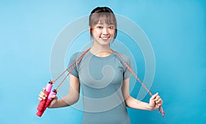 Young asian woman wearing gym suit on blue background