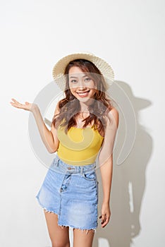 Young Asian woman wearing round hat with expression of surprise isolated on white background