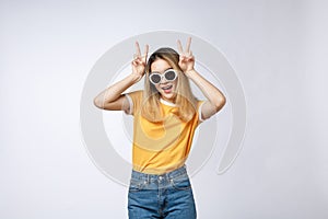 Young asian woman wearing sunglasses over isolated background showing and pointing up with fingers number two while