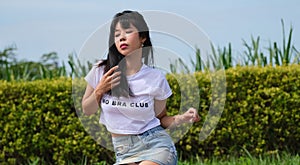 Young Asian woman wears unbranded white t-shirt