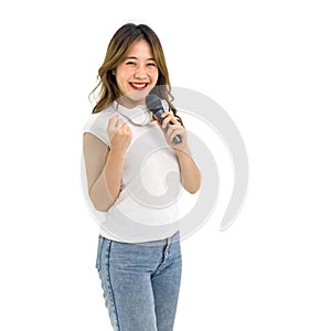 Young asian woman in white t-shirt and jean stand smiling with headphone on her neck, singing with microphone. Portrait on white