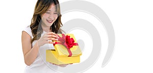 Young asian woman in white t-shirt opening a gift box received for a special occasion. Portrait on white background with studio