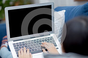 Young asian woman work from home with laptop computer blank screen mockup, freelance girl using notebook with empty.