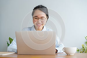 Young asian woman working on laptop in the home office desk