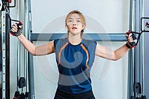 Young Asian woman working out and doing fitness training at a lo