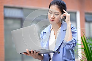 Young Asian woman working outside