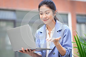 Young Asian woman working outside
