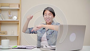 Young asian woman working using laptop on desk in living room at home. Asia business woman success celebration feeling happy