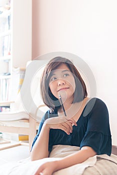 Young asian woman writing.