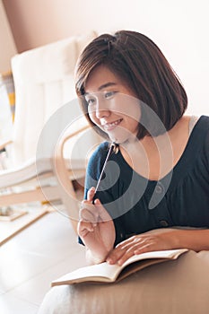 Young asian woman writing.