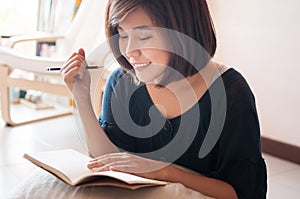 Young asian woman writing.