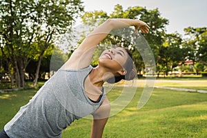 Young asian woman yoga outdoors keep calm and meditates while practicing yoga.