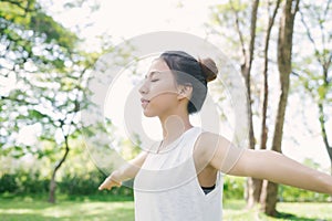 Young asian woman yoga outdoors keep calm and meditates while practicing yoga to explore the inner peace.