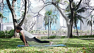 Young asian woman yoga outdoors keep calm and meditates while practicing yoga to explore the inner peace.