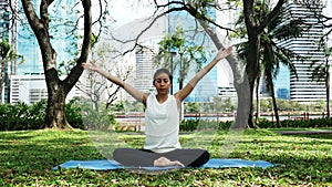 Young asian woman yoga outdoors keep calm and meditates while practicing yoga to explore the inner peace.