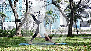 Young asian woman yoga outdoors keep calm and meditates while practicing yoga to explore the inner peace.