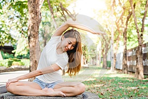 Young asian woman yoga outdoors keep calm and meditates while practicing yoga to explore the inner peace.